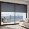 black sunscreen roller blind installed in a living room - Value Blinds NZ